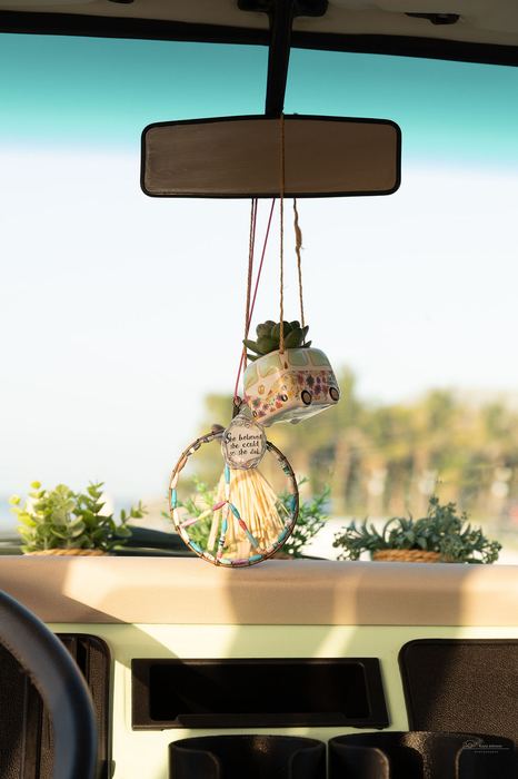 Dashboard details with a hanging peace-sign ornament