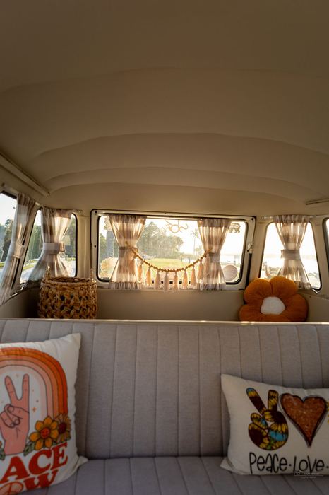 Interior ceiling and bench view with peace-sign pillows