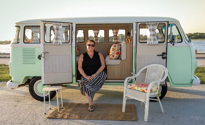 Guest sitting in Darla's doorway near the water