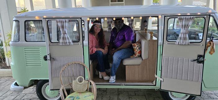 Couple in retro costumes posing in Darla's doorway