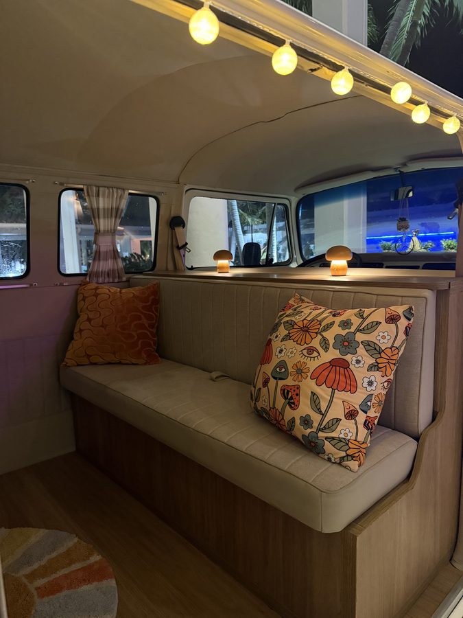 Guest smiling from inside Darla the VW bus